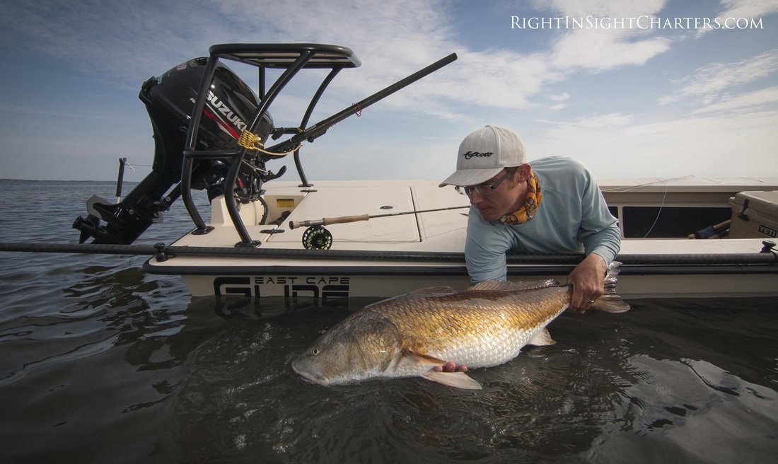 Capt. Justin Price from Right in Sight Charters releasing a redfish form the starboard beam from the ECS Glide shallow water skiff.